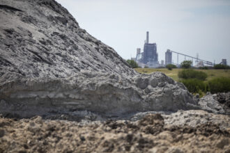 A view of the San Miguel Electric Cooperative power plant, with coal ash in the foreground. April 26, 2019. Credit: Miguel Gutierrez Jr./The Texas Tribune