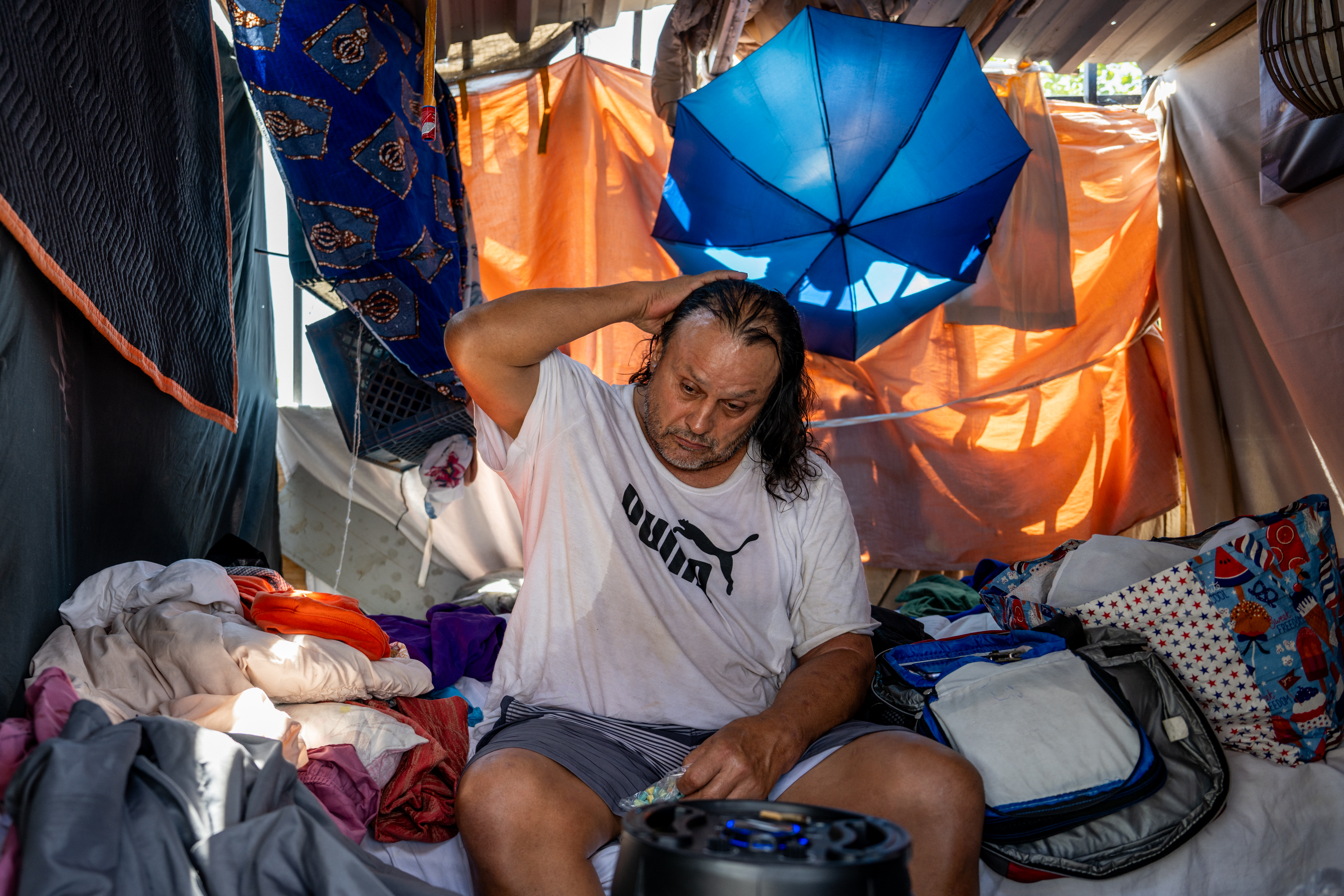 Homeless Phoenix resident Michael Soes sits in his tent after missing the bus to a cooling center on July 14, 2023. Today marks the Phoenix area's 15th consecutive day of temperatures exceeding 110 degrees. Record-breaking temperatures continue soaring as prolonged heatwaves sweep across the Southwest. Credit: Brandon Bell/Getty Images