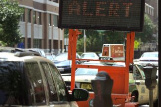 In a file photo, a sign reads "Heat Alert" and warns drivers and pedestrians about excessive heat in Chicago. Credit: Tim Boyle/Getty Images.