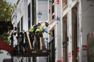 Workers install windows in a townhome complex under construction on May 15, 2017 in Chicago, Illinois. Credit: Scott Olson/Getty Images