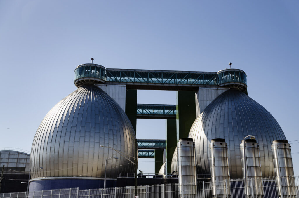 Anaerobic digesters and their flare stacks stand on Kingsland Ave. at the Newtown Creek wastewater treatment plant in Greenpoint, Brooklyn. Credit: Jake Bolster
