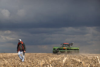 John Duffy walks across a field he is planting in soybeans on April 23, 2020 near Dwight, Illinois. Credit: Scott Olson/Getty Images