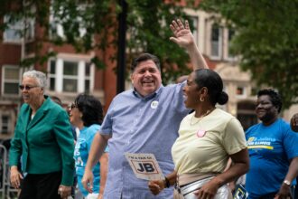 Illinois Governor JB Pritzker and Lieutenant Governor Juliana Stratton walk in the 93rd annual Bud Billiken Parade, held on King Drive in Chicago, Illinois, on August 13, 2022.