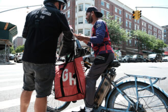 William, an organizer with the Workers Justice Project, speaks to delivery workers outside of a restaurant that uses app deliveries on July 07, 2023 in New York City.