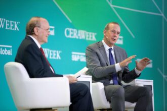 Chevron CEO Mike Wirth (R) speaks with S&P Global Vice Chairman Daniel Yergin during CERAWeek by S&P Global in Houston, Texas on March 6, 2023. Credit: Mark Felix/AFP via Getty Images