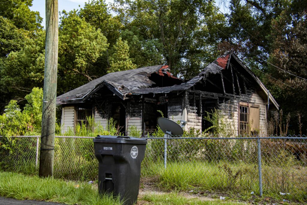 Remnants of burned down homes are a common sight in Alabama Village. Credit: Lee Hedgepeth/Inside Climate News. 