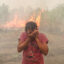 A woman reacts as a wildfire burns at Palem Raya Regency in Ogan Ilir, South Sumatera, Indonesia on September 18, 2023. Indonesian authorities are struggling to put out forest and land fires that have been engulfing many parts of the country, including fire-prone regions in Sumatra and Borneo, as the country enters the hottest day of this year's El Nino-induced dry season Credit: Muhammad A.F/Anadolu Agency via Getty Images