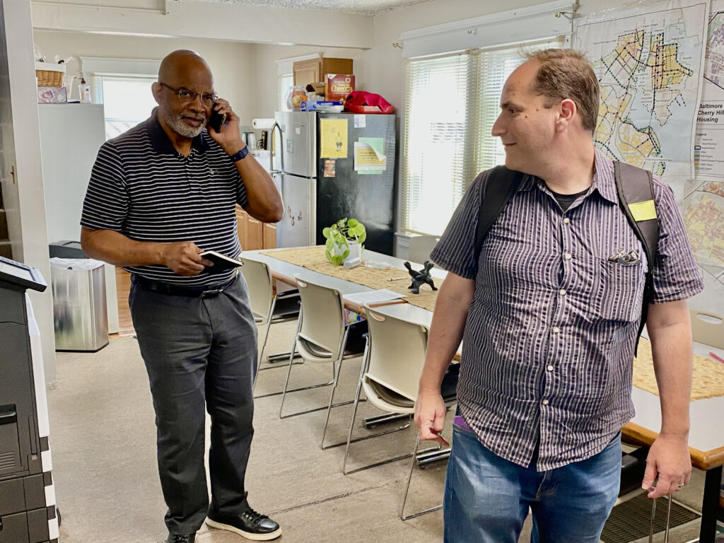 Brad Rogers, right, looks at Rev. Richard Partlow, the interim executive director of Cherry Hill Development Corporation, as they get ready to leave for a meeting at the nearby office of Cherry Hill Strong - a community partner organization. Credit: Aman Azhar / Inside Climate News