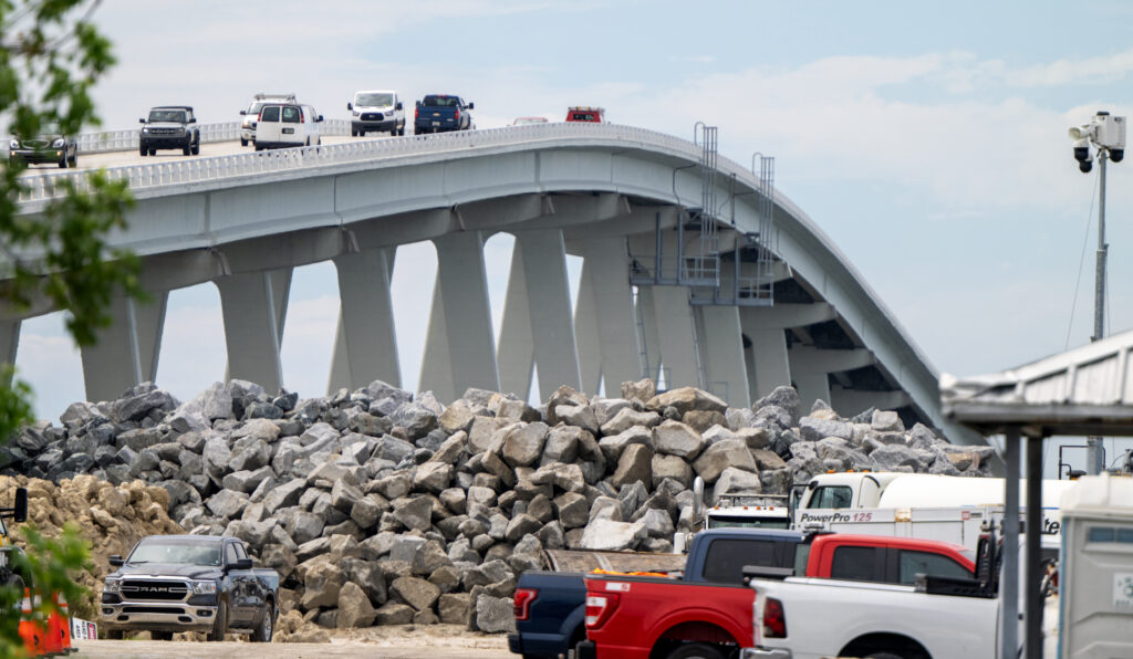 Mounds of rock remain roadside on September 27, 2023 to be used to reinforce the Sanibel Causeway after the intense winds and floods of Hurricane Ian damaged the causeway a year earlier. Credit: Chris Tilley