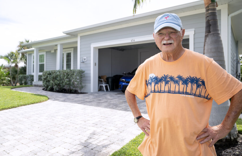 Jim Delaney in front of his home on Sanibel Island on September 27, 2023. Jim recently moved back into his beloved home after the flood waters of Hurricane Ian led to him being rescued by Coast Guard helicopter rescue teams and the damage the storm did to his house prevented his return home. (Photo by Chris Tilley)