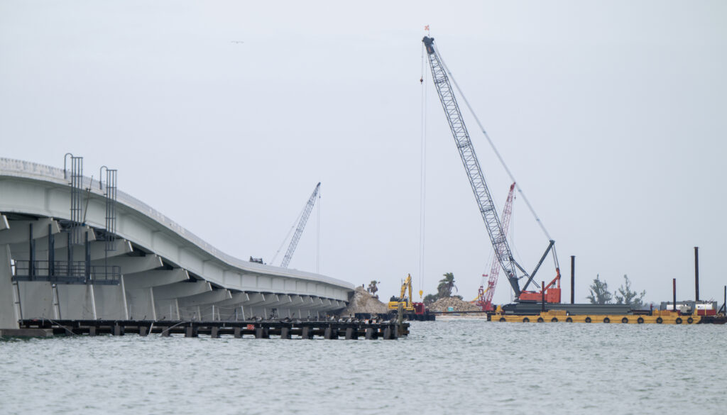 After the intense winds and floods of Hurricane Ian damaged the Sanibel causeway, construction work continues a year after the storm to repair the devastation. Credit: Chris Tilley
