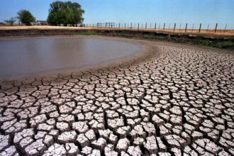 A stock pond south of Dallas dries up due to drought conditions. Across Texas, drought is taxing reservoirs and rivers and groundwater aquifers are being pumped faster than they can recharge. Currently, more than half the state is in drought. Credit: Paul Buck/AFP via Getty Images.
